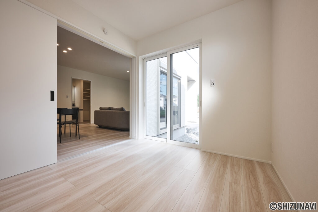 LDK横に設計された約5.4帖の洋室。大きな窓から光がたっぷり入り、明るく心地よい空間です。リビングと引き戸でつながっているため、開ければ広々とした一体感が生まれ、閉めれば個室としても活用可能。